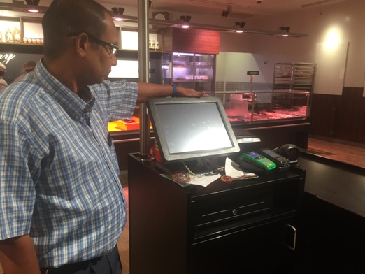 The owner of Madang Butchery admiring his new POS System